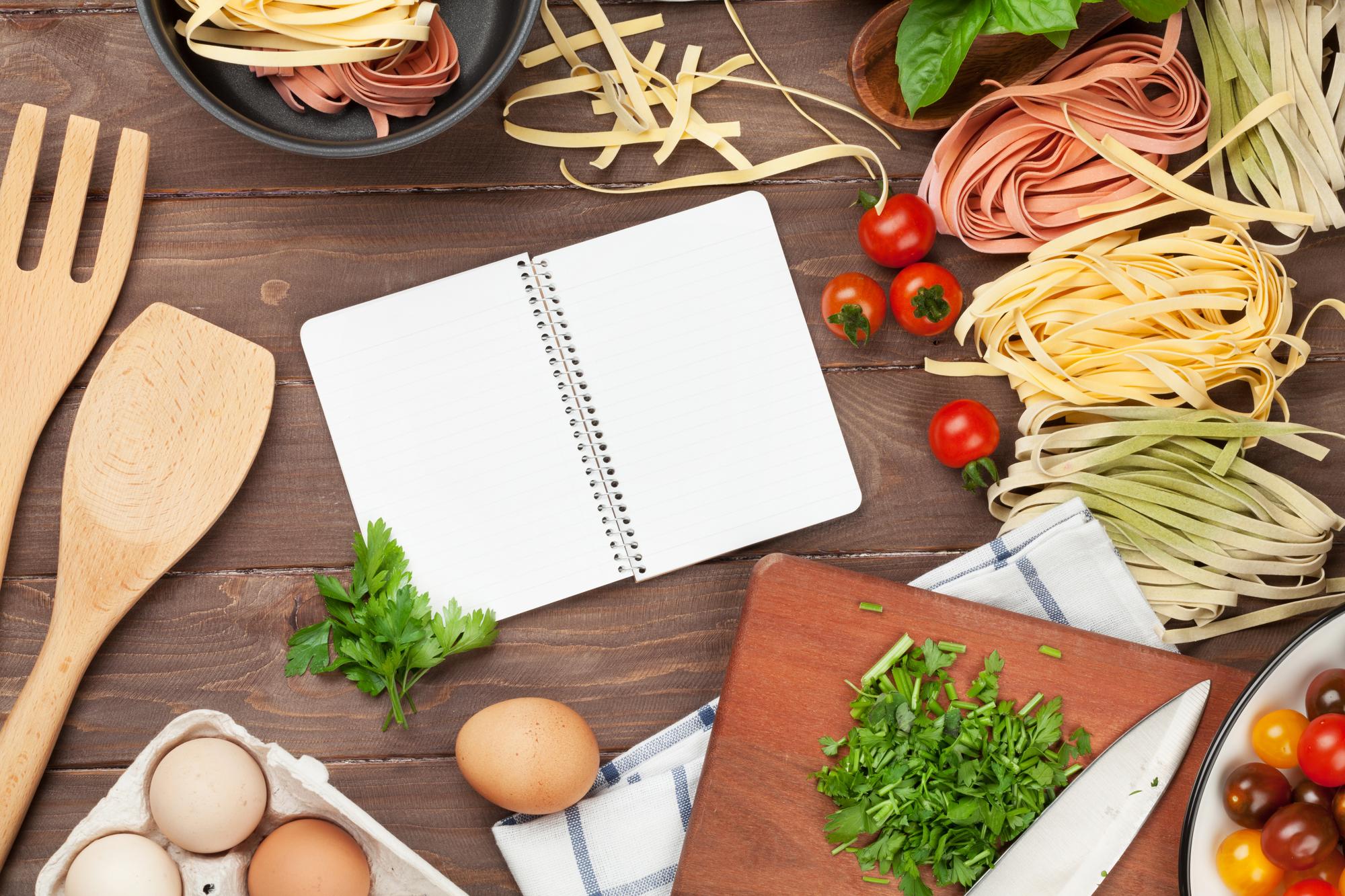 Set di ingredienti e note di ricetta su tavolo